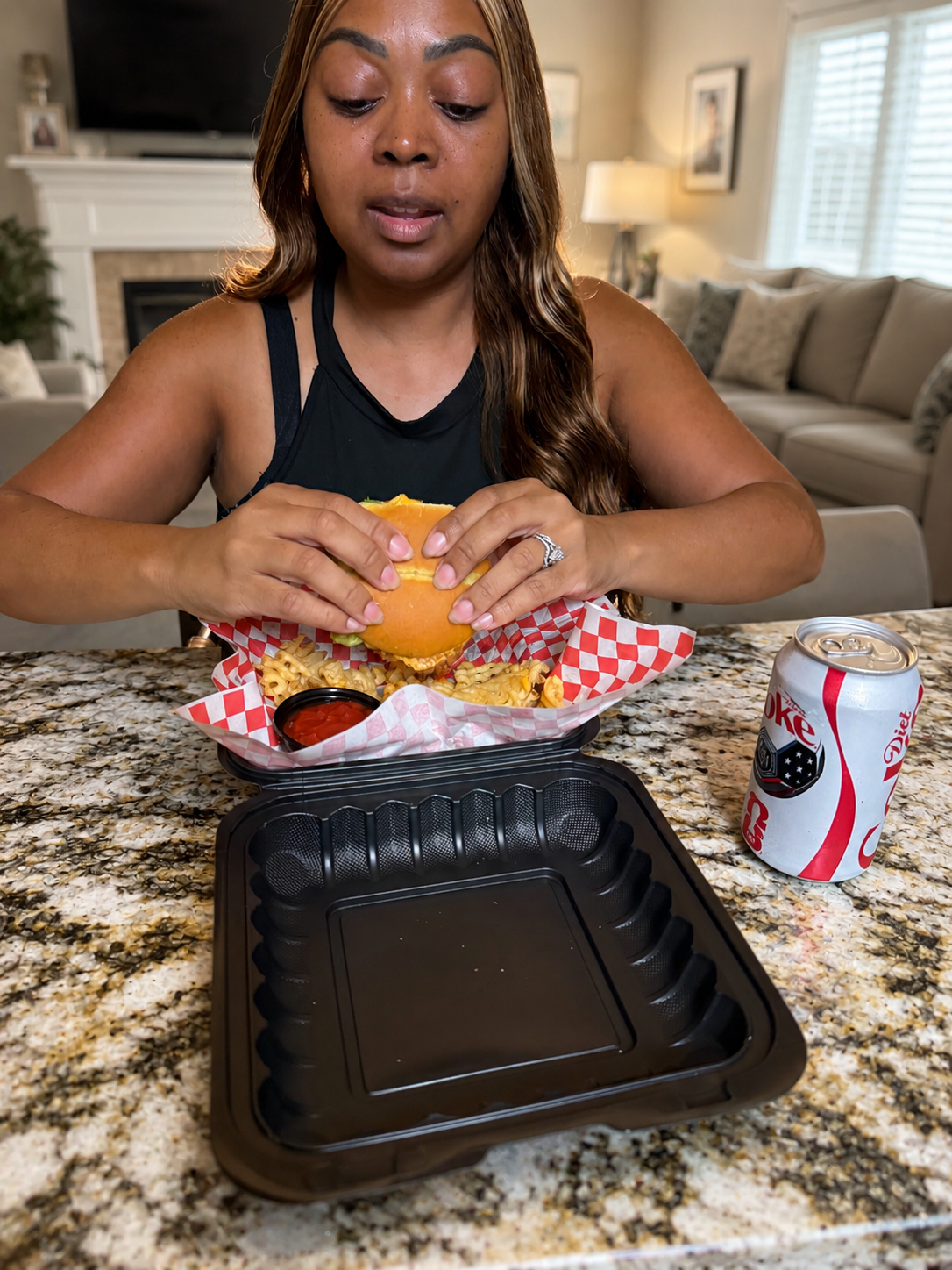 Customer holding a chicken sandwich combo with fries and a drink